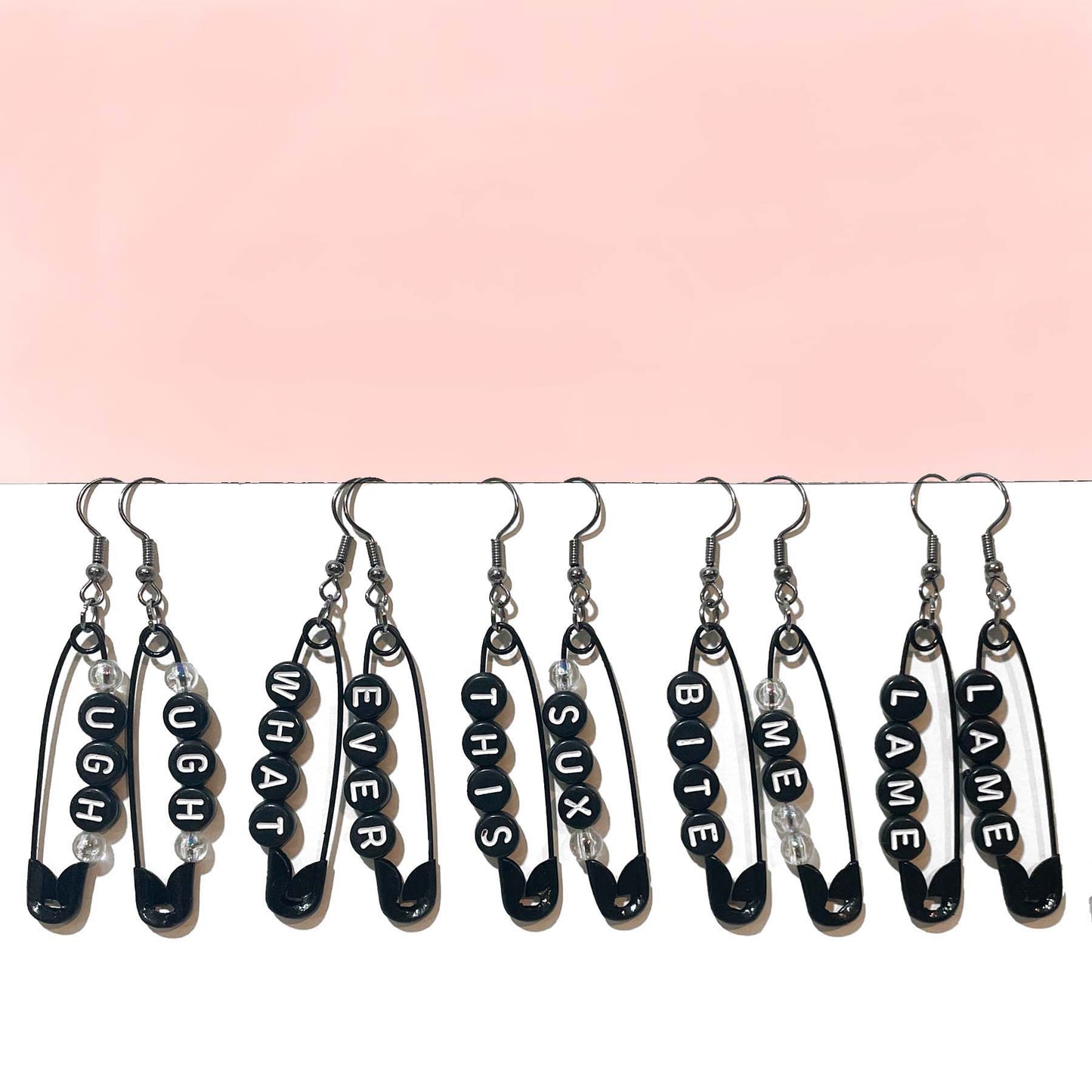 handmade safety pin earrings with profanity sayings.