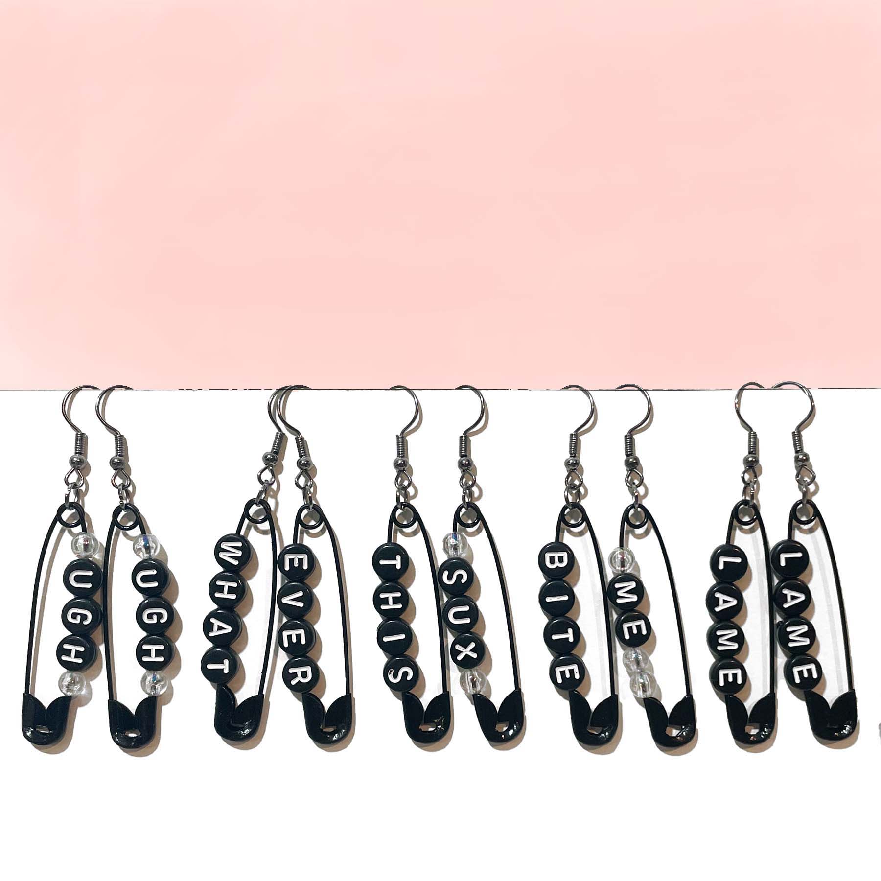 handmade safety pin earrings with profanity sayings.